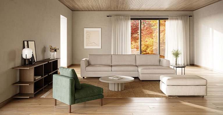 A large sectional sofa sits in a living room with oak floors. Link to ready to ship category