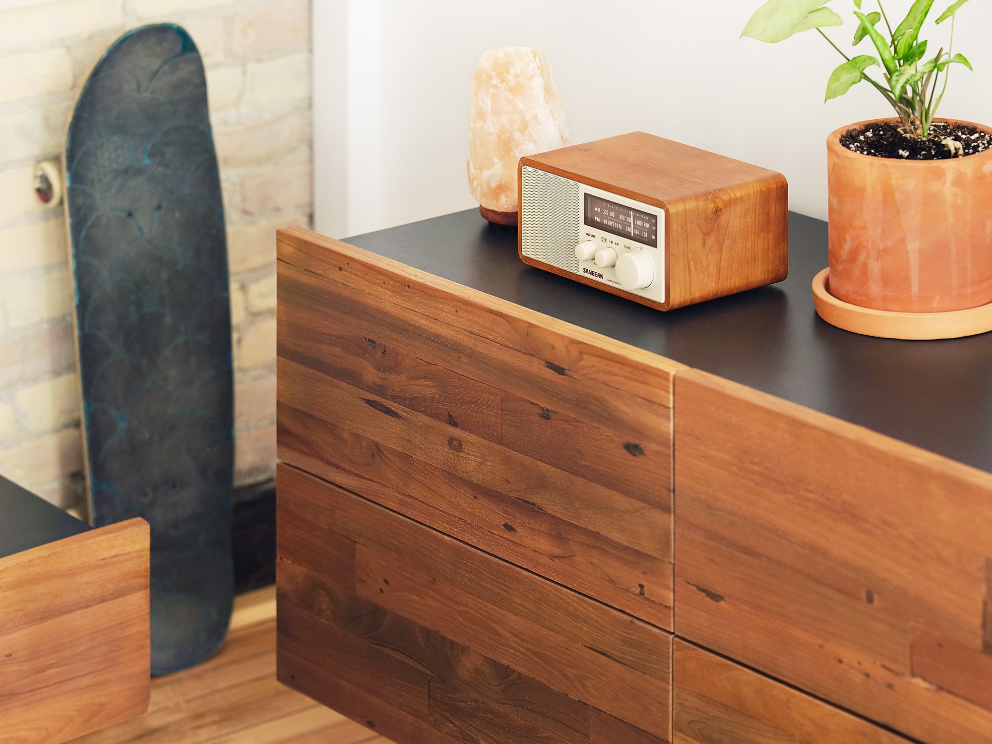 small radio sits on a corner of the Reclaimed Teak Modern Dresser