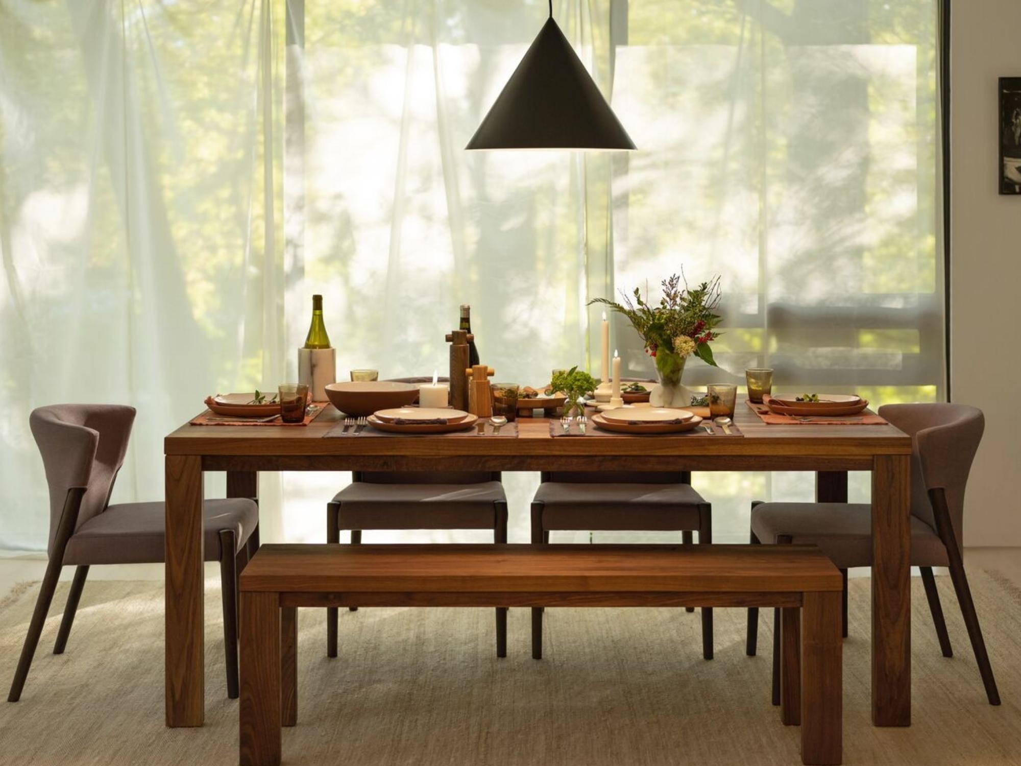 Grey upholstered and black oak dining chairs around an oak table