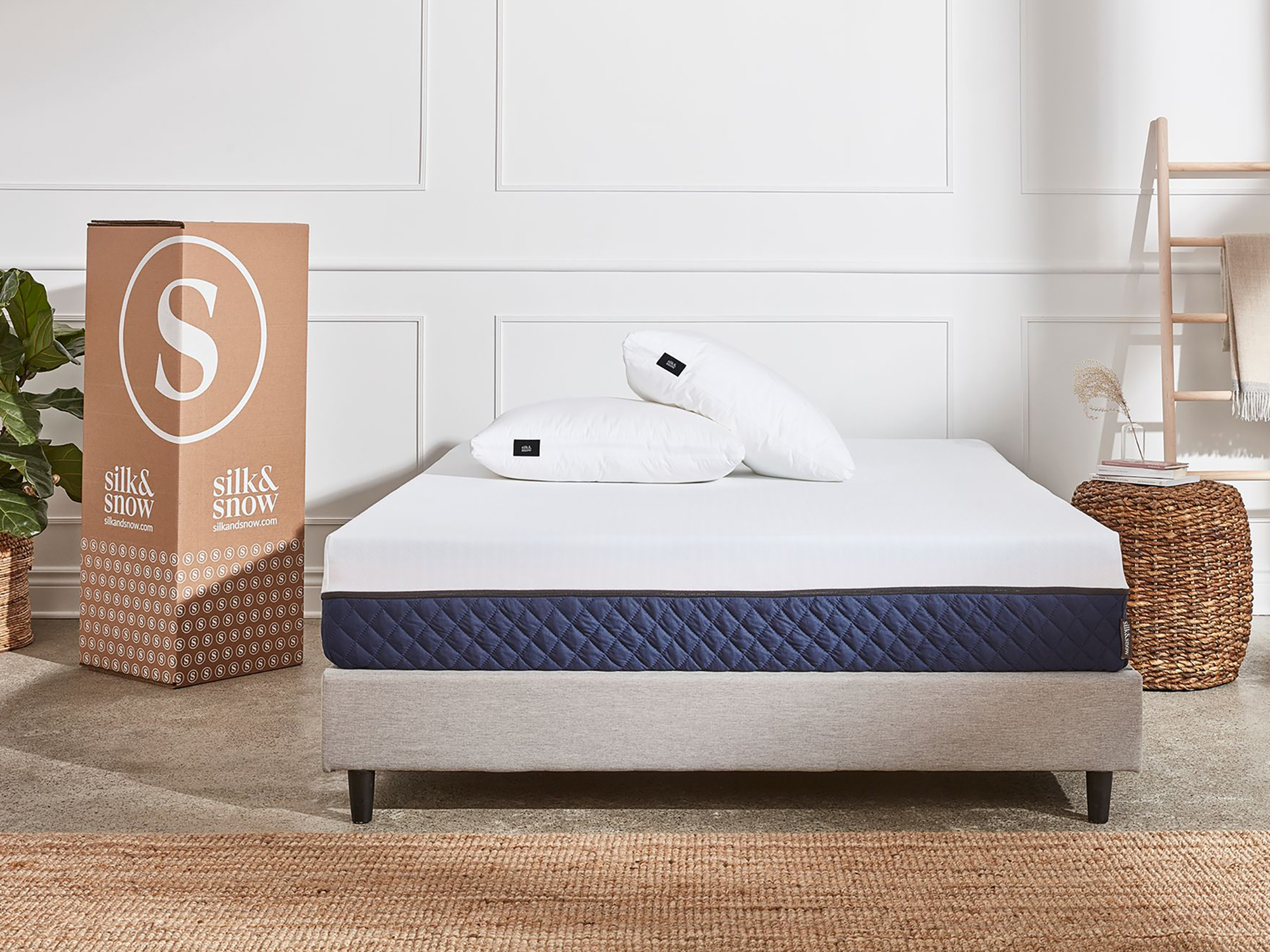 Modern bedroom featuring blue and white foam mattress on bed frame