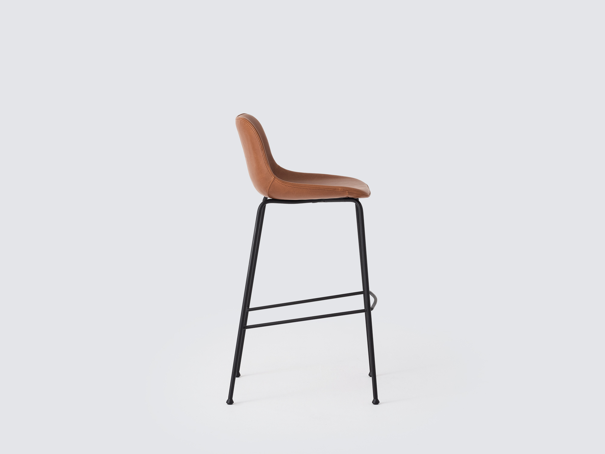 Side view of the Oles counter height bat stool with brown leather seat