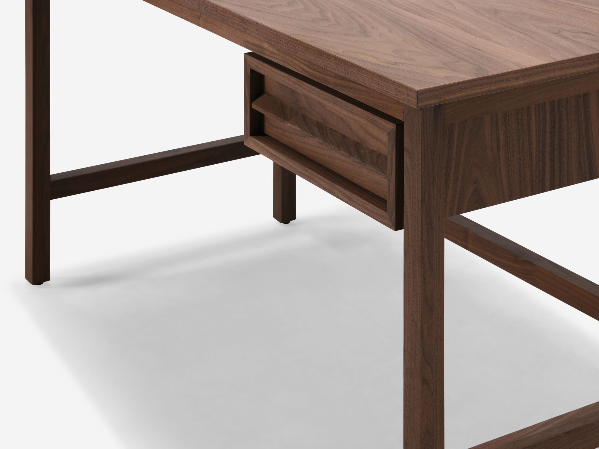 Detail view of walnut desk with drawer