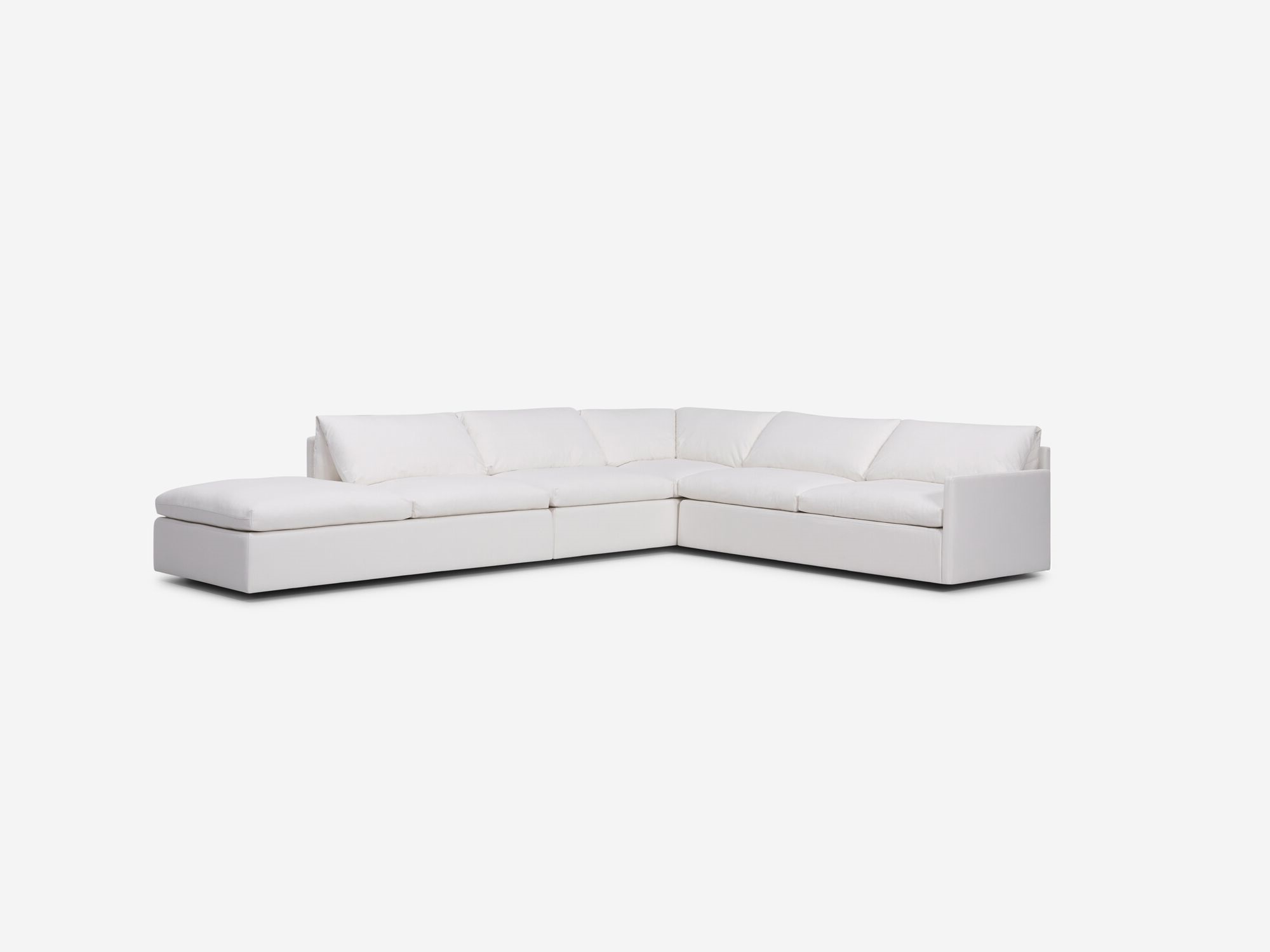 Left angle view of white sectional sofa with narrow arms and left hand chaise