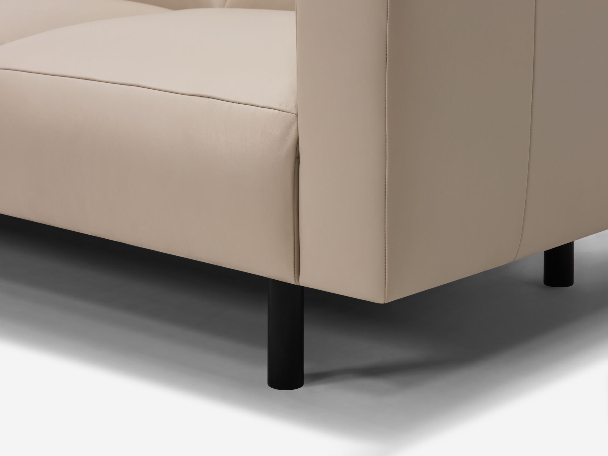 Beige leather sectional leg detail view